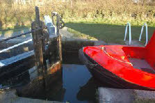 Paddle open, boat going down. Take care to keep the front of the boat clear of the gates